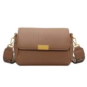Brown lychee leather crossbody bag with vintage geometric woven shoulder strap and gold buckle