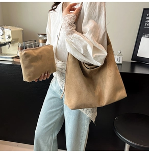Detail showing the large faux suede tote bag and matching clutch set in khaki brown color