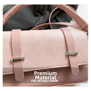 Detail of pink faux leather bag with checkered texture and silver metallic hardware