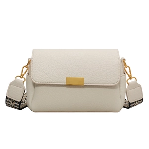 Minimalist beige pebble leather crossbody bag with ethnic patterned wide shoulder strap