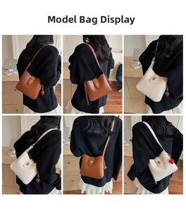 Detail of minimalist bucket bag showing sleek PU leather texture and gold buckle charm