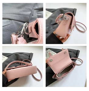 Detailed interior of a pink leather crossbody bag with zipper pocket and silver hardware