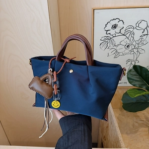 Casual nylon tote bag for women, waterproof commuter shoulder crossbody handbag with cute charms.