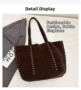Close-up of silver studs on dark brown suede tote bag with durable shoulder straps