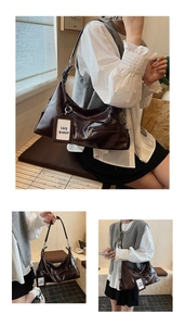 Close-up of deep brown glossy faux leather shoulder bag with stylish zipper pocket