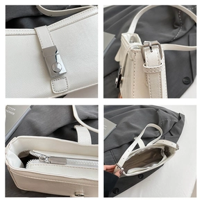Detailansicht der weißen Lederhandtasche mit Silberverschluss und verstellbarem Riemen
