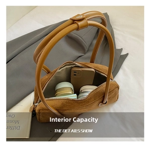 Macro view of brown suede baguette bag showing large interior capacity and sleek lining