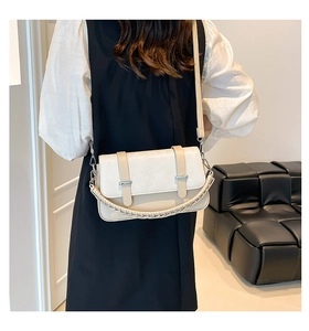Rear view of cream woven handle crossbody bag styled with a minimalist dress