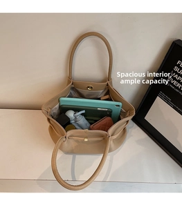 Interior view of large khaki tote bag showing iPad, phone, and daily essentials