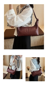 Detailed close-up of a burgundy leather half-moon shoulder bag with knot strap accents