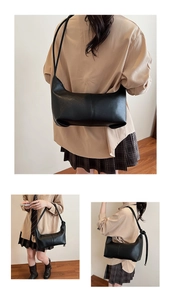 Close-up of black leather bucket bag featuring vertical stitching and adjustable strap