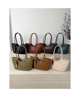 Detail view of woven tote bags in multiple colors with stylish bead tassel charms