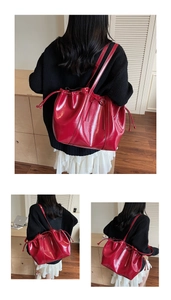Detail of red glossy tote bag with drawstring closure and delicate bow decoration