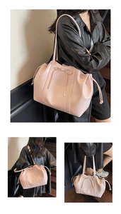 Pink glossy faux leather tote bag with bow detail and drawstring closure shown on a model