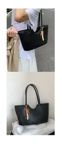Detail of black woven leather tote bag with colorful ethnic tassel and wood bead pendant