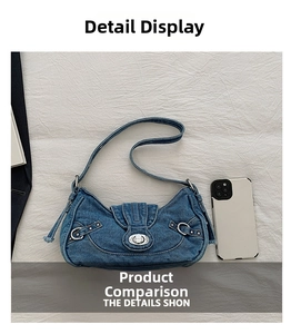 Detail of blue denim hobo bag showing size comparison with a smartphone and silver lock