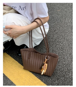 Detailed shot of dark brown woven tote bag with checkerboard pattern and wooden beads