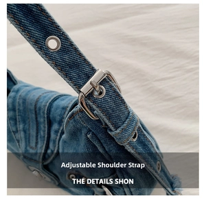 Detail of adjustable denim shoulder strap with silver eyelets and metal buckle