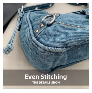 Detail of light blue denim fabric texture with orange stitching and silver rivets