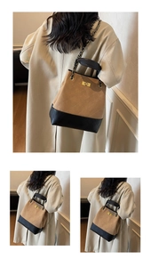 Detail of bicolored bucket bag showing quilted texture and gold metal rotating lock