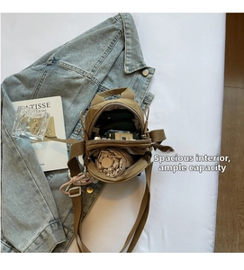 Detail view of the spacious inner compartment of the khaki canvas crossbody bag