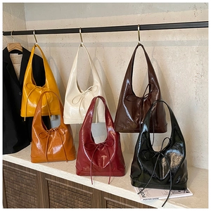 Glossy oil wax leather tote bags with bow detail shown in multiple vibrant colors