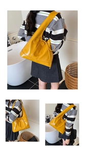 Macro detail of ginger yellow bow bucket bag showing glossy texture and drawstring
