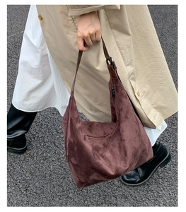 Detail of dark brown suede hobo bag showing large capacity and soft texture