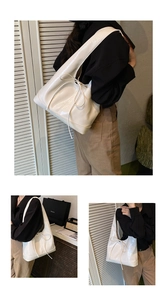 Close-up of cream white glossy leather tote bag with delicate drawstring bow detail