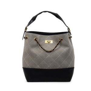 Quilted gray tote bag with black trim, gold chain, and twist lock in a modern minimalist style
