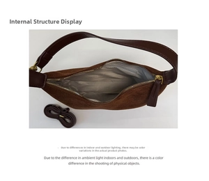 Detail of brown suede tote interior featuring gray patterned lining and inner zip pocket