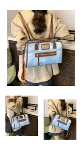 Detailed close-up showing blue denim texture and brown leather trim on the shoulder bag