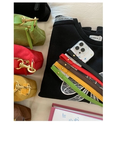 Close-up of colorful leather wrist straps with gold rivets on smartphone cases