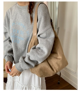 Detail of suede tote bag with leather strap paired with casual autumn fashion style