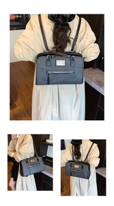 Detail view of black dual-use backpack with white contrast stitching and exterior zipper pocket