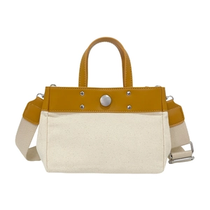 Bolso tote de lona con ribete de cuero amarillo y correa ajustable para uso diario casual