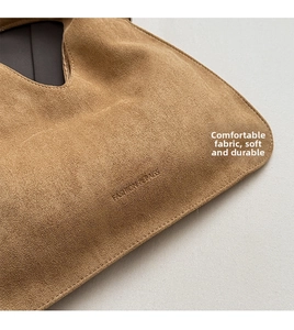 Close-up of brown suede material and FASHION & BAGS embossed lettering on the bag