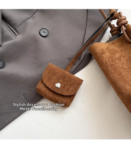 Detail of brown matte suede tote bag with a matching mini pouch and knot handle detail