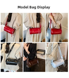 Close-up of vintage glossy leather cylinder bags in red, black, brown, and white colors
