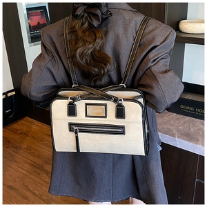 Close-up of contrast lace bow backpack with white stitching and silver metal plate detail