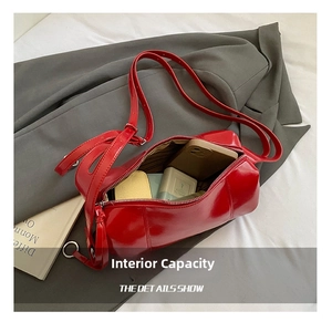 Internal capacity of red patent leather cylinder bag showing daily essentials
