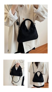 Detail of black suede tote bag with V-shaped opening and decorative knotted shoulder strap