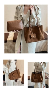 Detail of vintage brown suede tote bag and matching leather pouch set with textured finish