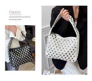 Detail of metal rivets and silver zipper on retro punk style PU leather handbag