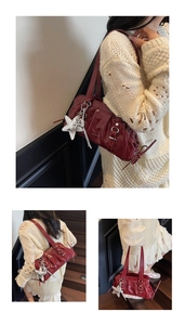 Detail view of burgundy patent leather shoulder bag with vintage pleats and star pendant