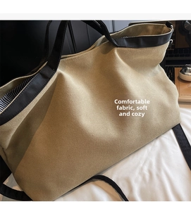 Detailed view of spacious canvas tote bag showing striped lining and soft khaki fabric