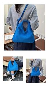 Detail of royal blue suede shoulder bag featuring chic knotted strap and silver hardware