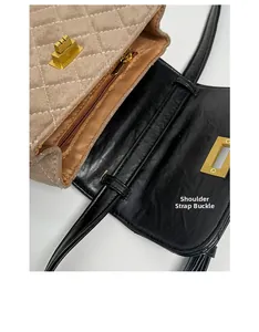 Close-up of quilted suede flap and metal swivel lock on the interior of a crossbody bag