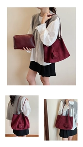 Detail view of burgundy matte tote bag and matching zipper clutch in high quality texture