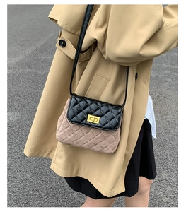 Detail of quilted leather crossbody bag with suede patchwork and gold twist lock clasp